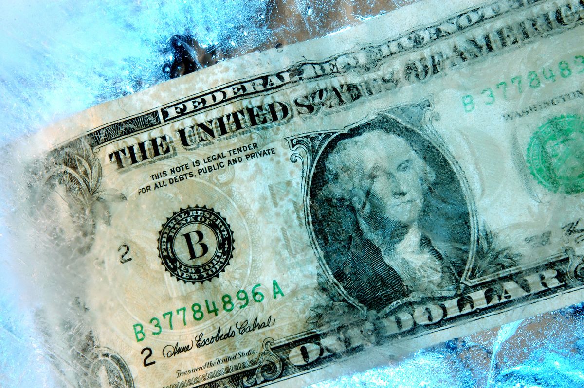 A U.S. one dollar note is frozen in a block of ice in this s