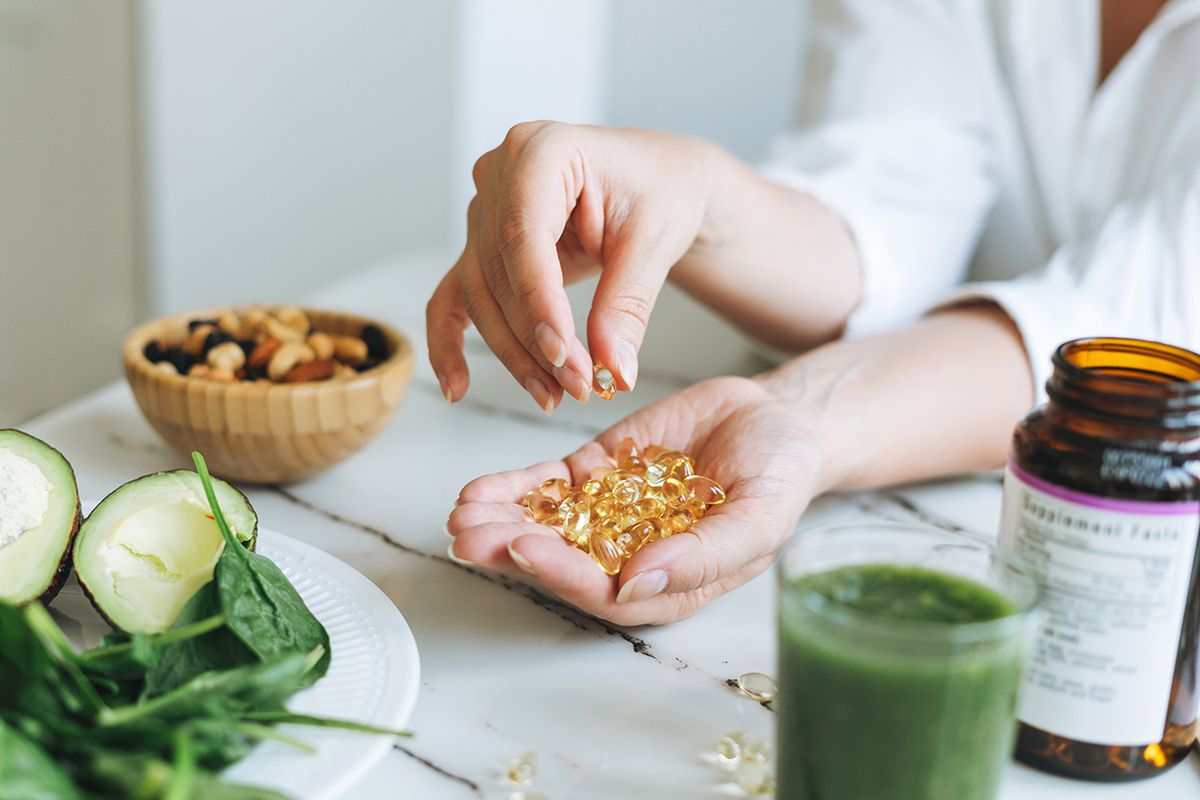 Woman Doctor Nutritionist Hands In White With Omega 3, Vitamin D Capsules With Green Vegan Food Photo taken in Yekaterinburg, Russia, vitaminok, vitamin,