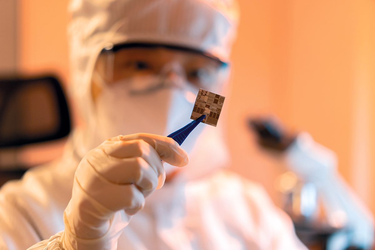 Female engineer inspecting wafer chip in dust-free laboratory, china, chip