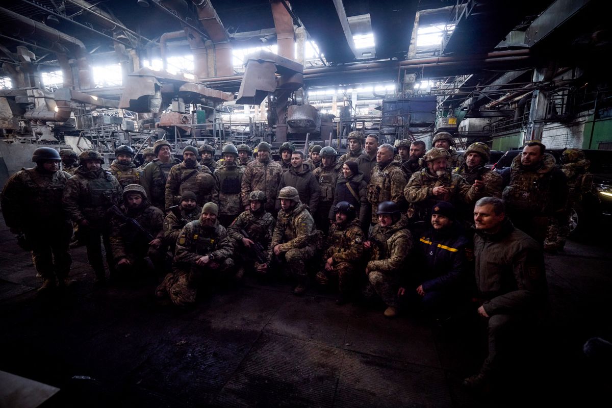 In this handout picture taken and released on December 20, 2022 by the Ukrainian Presidential press services Ukraine President Volodymyr Zelensky (C) poses as he meets with Ukrainian servicemen who have been holding back a fierce and months-long Russian military campaign for the city, as part of Zelensky's visit in the eastern frontline city of Bakhmut, now the epicentre of fighting in Russia's nearly 10-month invasion of Ukraine. 