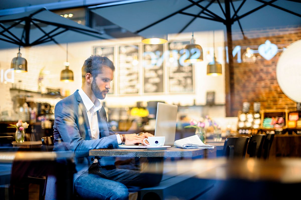 Businessman using laptop in a cafe, homeoffice, bar, pub, coffeeshop,