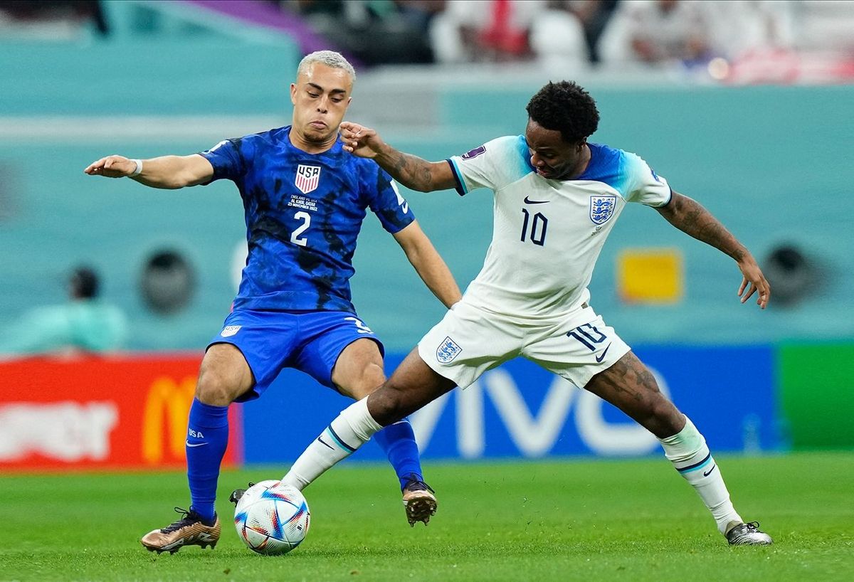 England v USA: Group B - FIFA World Cup Qatar 2022 Sergińo Dest Right-Back of USA and AC Milan and Raheem Sterling Left Winger of England and Chelsea FC compete for the ball during the FIFA World Cup Qatar 2022 Group B match between England and USA at Al Bayt Stadium on November 25, 2022 in Al Khor, Qatar. (Photo by Jose Breton/Pics Action/NurPhoto) (Photo by Jose Breton / NurPhoto / NurPhoto via AFP)