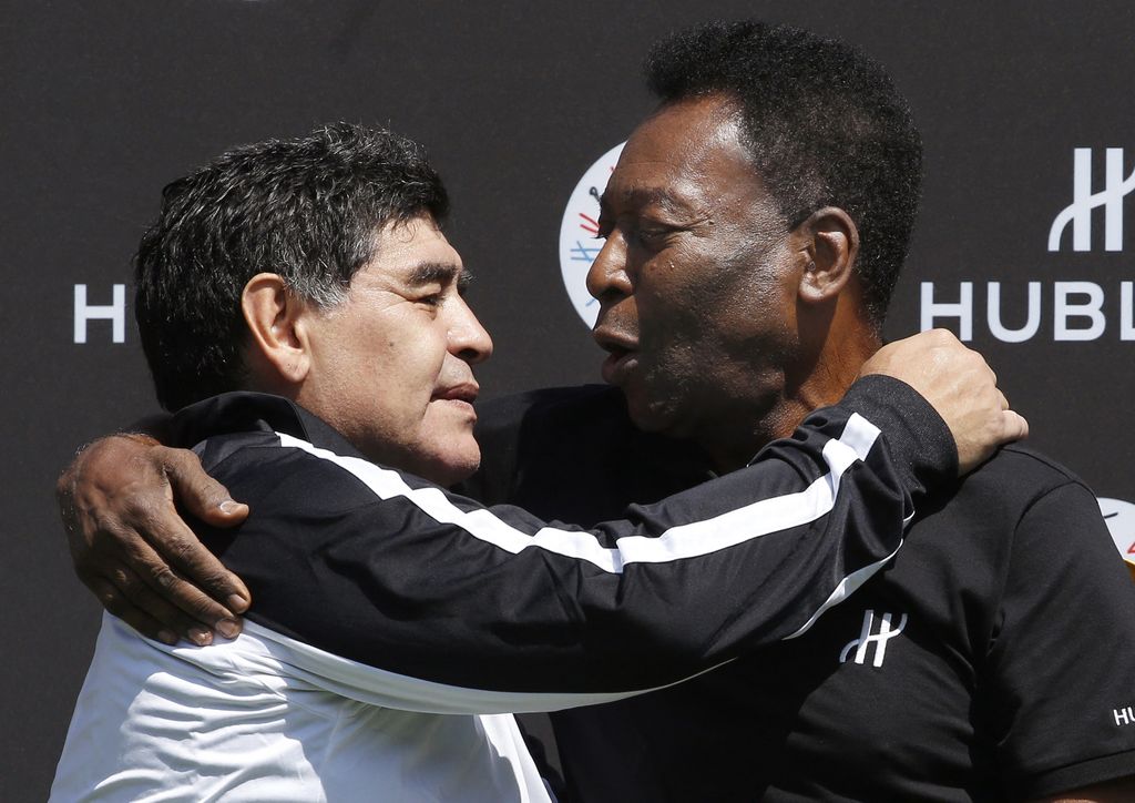 (FILES) In this file photo taken on June 09, 2016 Former Argentinian football international Diego Maradona (L) and former Brazilian footballer Pele pose after a football match organised by Swiss luxury watchmaker Hublot at the Jardin du Palais Royal in Paris on June 9, 2016, on the eve of the Euro 2016 European football championships. - Brazilian football icon Pele, widely regarded as the greatest player of all time and a three-time World Cup winner who masterminded the 'beautiful game', died on December 29, 2022 at the age of 82, after battling kidney problems and colon cancer. (Photo by PATRICK KOVARIK / AFP)