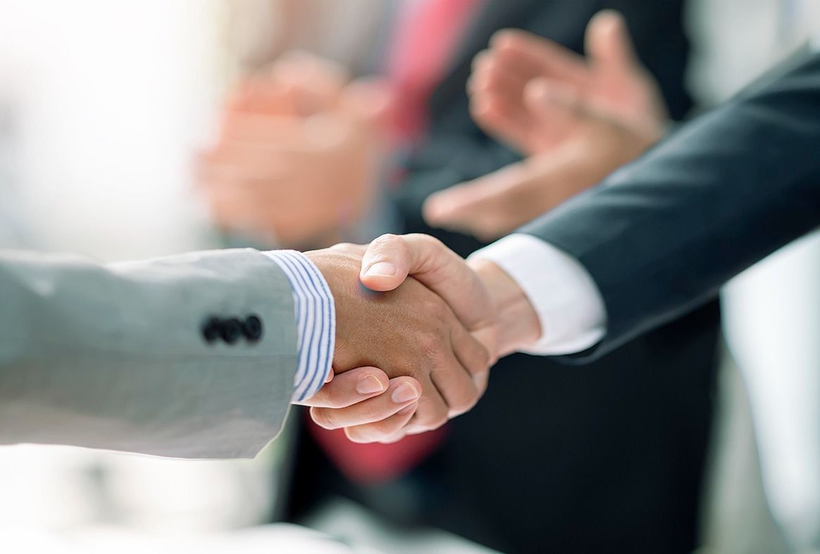 Two Businessman handshake for teamwork of business merger and acquisition at office.