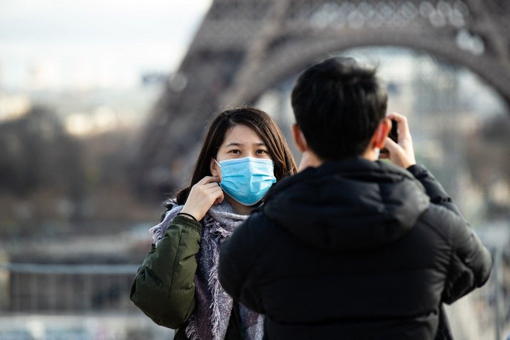 Tourists Wear Face Mask To Protect Against The Coronavirus In Paris