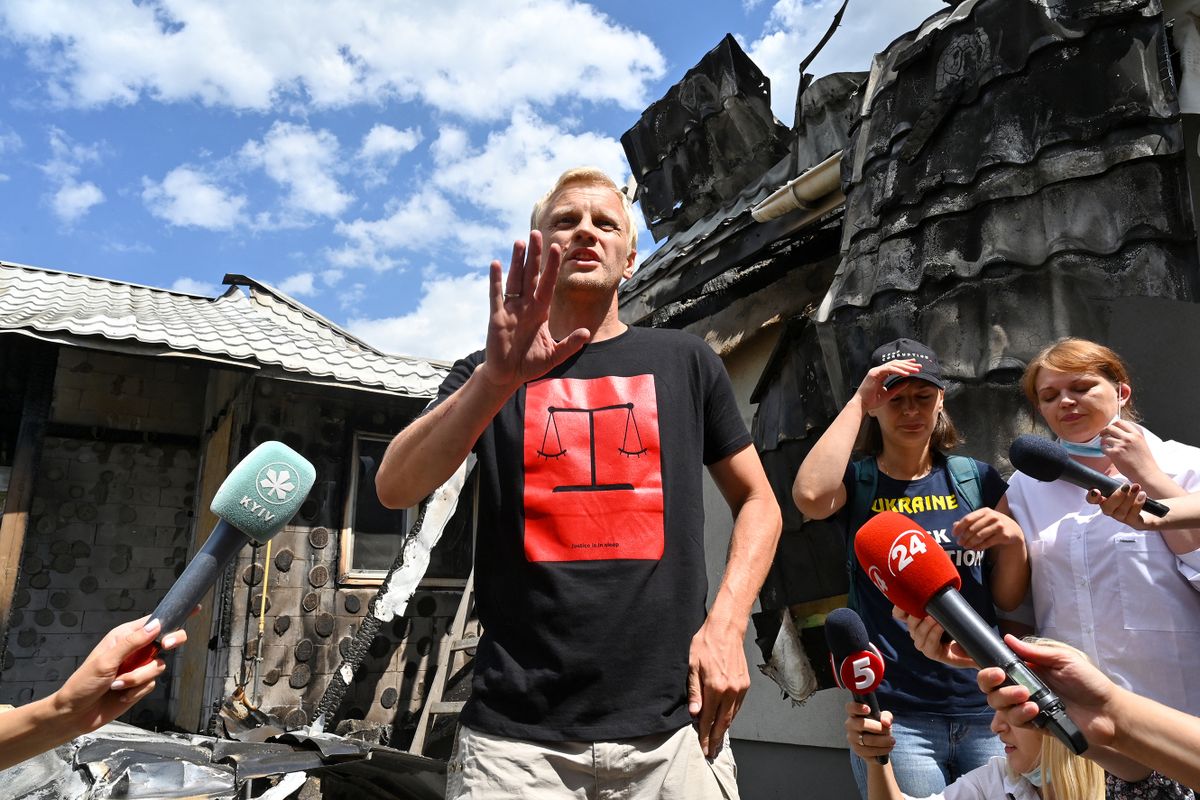 Ukrainian anti-corruption campaigner Vitaly Shabunin speaks with journalists in front of his damaged house after it was set on fire in the village of Gnidyn outside Kiev on July 23, 2020. 
