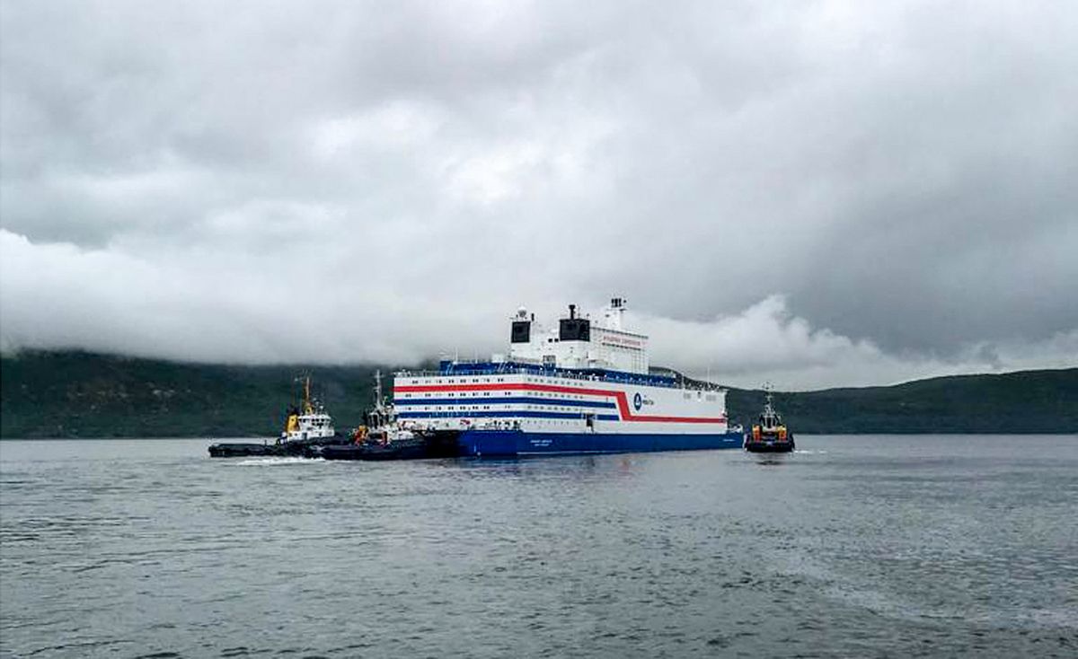 This handout picture taken and released on August 23, 2019, by the Russian nuclear agency ROSATOM shows the floating power unit (FPU) Akademik Lomonosov being towed from the Arctic port of Murmansk, northwestern Russia. - Russia launched the world's first floating nuclear reactor, sending it on an epic journey across the Arctic on August 23, despite environmentalists warning of a "Chernobyl on ice."Loaded with nuclear fuel, the Akademik Lomonosov left the Arctic port of Murmansk to begin its 5,000 kilometre (3,000-mile) voyage to Pevek in northeastern Siberia. 