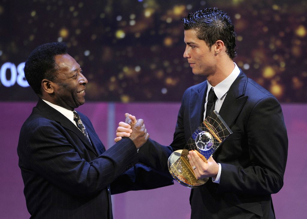 (FILES) In this file photo taken on January 12, 2009 Portuguese football player Cristiano Ronaldo (R) receives congratulations from Brazilian football legend Pele after recieving the FIFA world footballer of the year 2008 award in Zurich. - Brazilian football icon Pele, widely regarded as the greatest player of all time and a three-time World Cup winner who masterminded the 'beautiful game', died on December 29, 2022 at the age of 82, after battling kidney problems and colon cancer. (Photo by Fabrice COFFRINI / AFP)