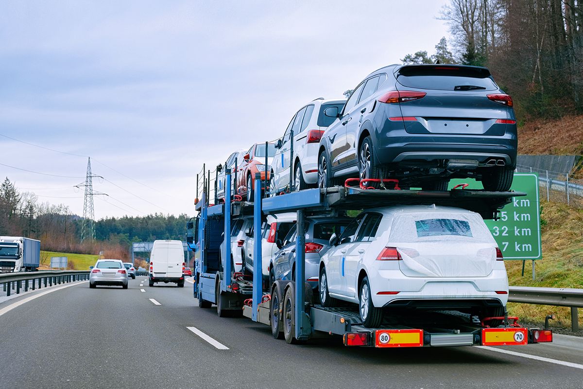 Car,Carrier,Transporter,Truck,On,Road.,Auto,Vehicles,Hauler,On Car carrier transporter truck on road. Auto vehicles hauler on driveway. European transport logistics at haulage work transportation. Heavy haul trailer with driver on highway.