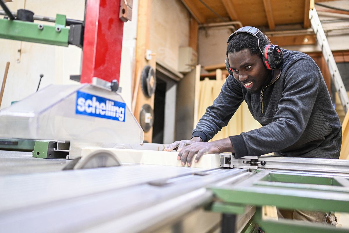 Refugee Omar Ceesay works as a carpenter