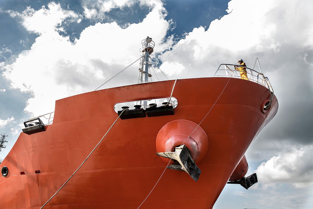 Low angle view of worker on board oil tanker