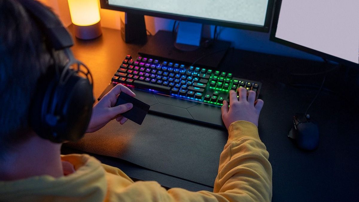 Boy holding credit card while playing video game at home Boy, gamer, personal computer, streamer, network, internet, dontation, online, games