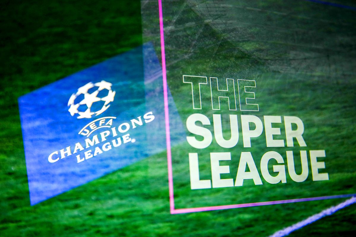 The Super League Photo Illustrations UEFA Champions League logo displayed on a phone screen and The Super League logo displayed on a screen are seen in this multiple exposure illustration photo taken in Krakow, Poland on April 20, 2021. (Photo Illustration by Jakub Porzycki/NurPhoto) (Photo by Jakub Porzycki / NurPhoto / NurPhoto via AFP)