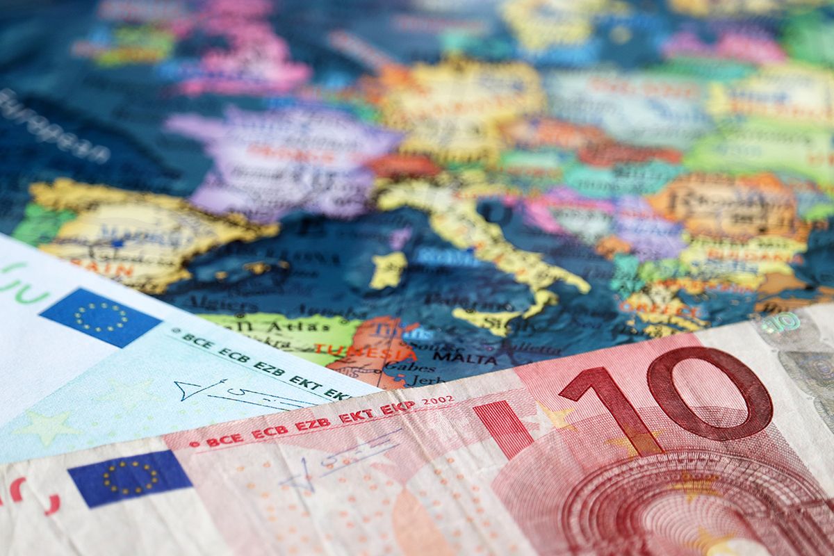 Euro banknotes on the map of Europe, selective focus. Concept for european economy, eurozone countries Euro banknotes on the map of Europe, selective focus. Concept for european economy, eurozone countries