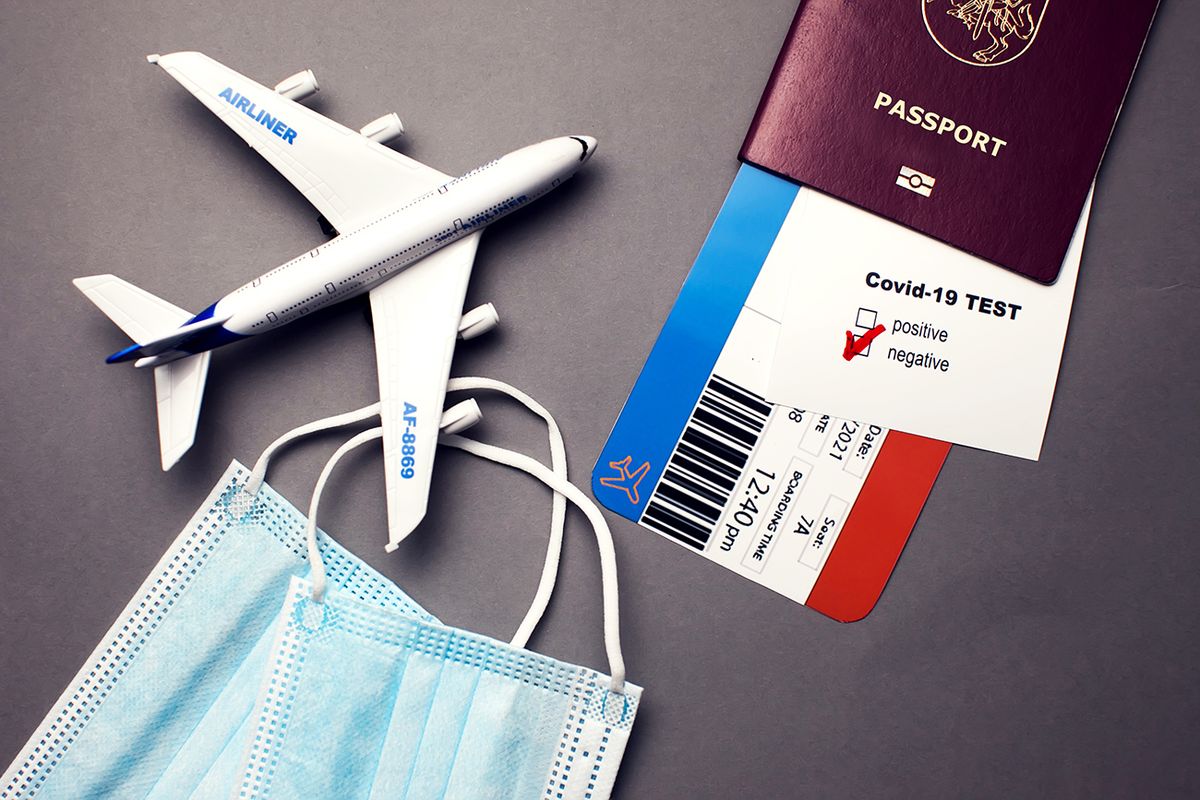 Traveling,During,Covid-19,Pandemic,,Passport,With,Airline,Ticket,,Covid-19,Negative Traveling during COVID-19 pandemic, passport with airline ticket, covid-19 negative test, medical masks and plane on grey background, airport security health and safety check concept
