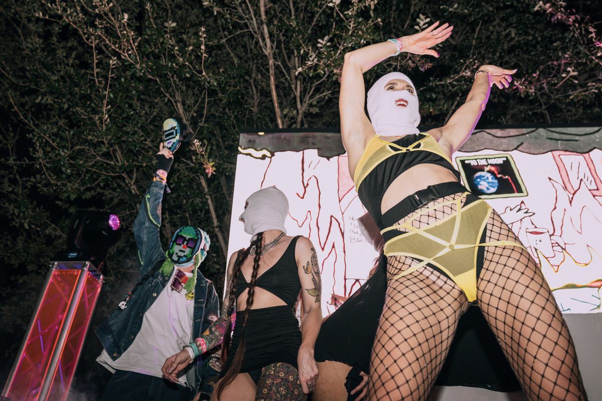 MIAMI, UNITED STATES - DECEMBER 2: NFT collector CyptoNovo (L) joins the Pussy Riot performers on stage during the Cryptopunk party at the Institute of Contemporary Art (ICA) in Miami, Florida on December 2, 2022. 