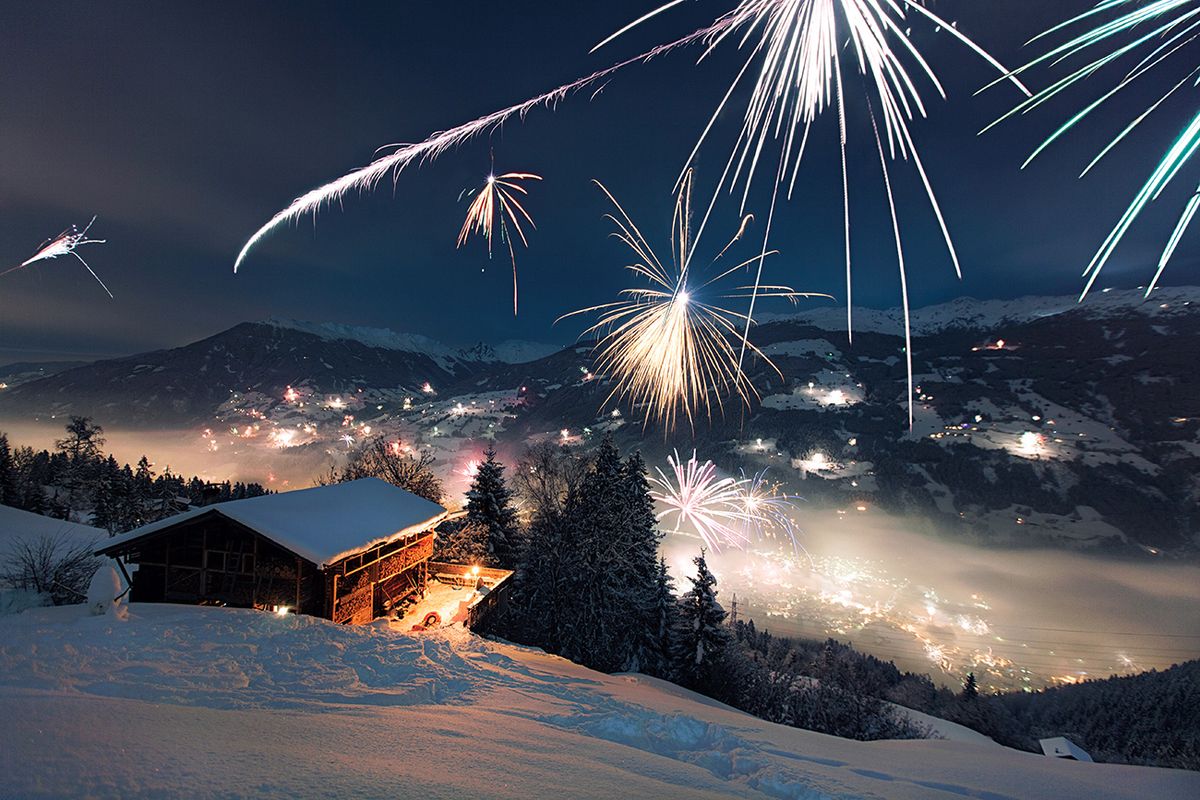 Firework and Ski Cabin Snow-covered ski cabin at New year's eve fireworks.