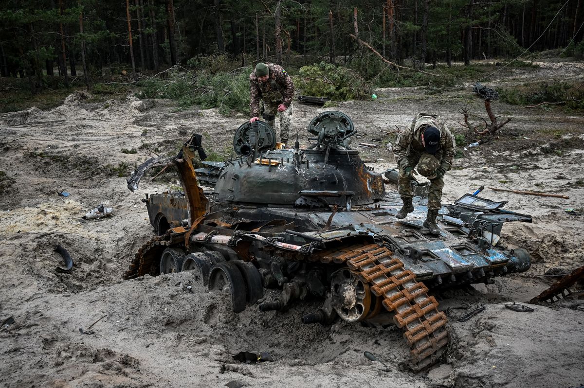 Ukrainian servicemen inspect a destroyed Russian tank near Kivsharivka village in a suburb of Kupiansk, Kharkiv region on December 15, 2022, amid the Russian invasion of Ukraine.