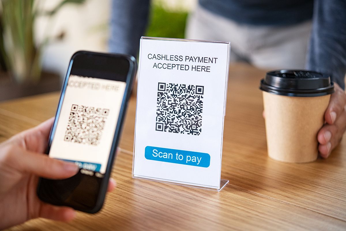 Customer,Scanning,Tag,In,Coffee,Shop,To,Pay,Online.,Close Customer scanning tag in coffee shop to pay online. Close up of hand scanning qr code for cashless payment at cafeteria. Girl framing qr code to make a purchase, small business accepts digital payment