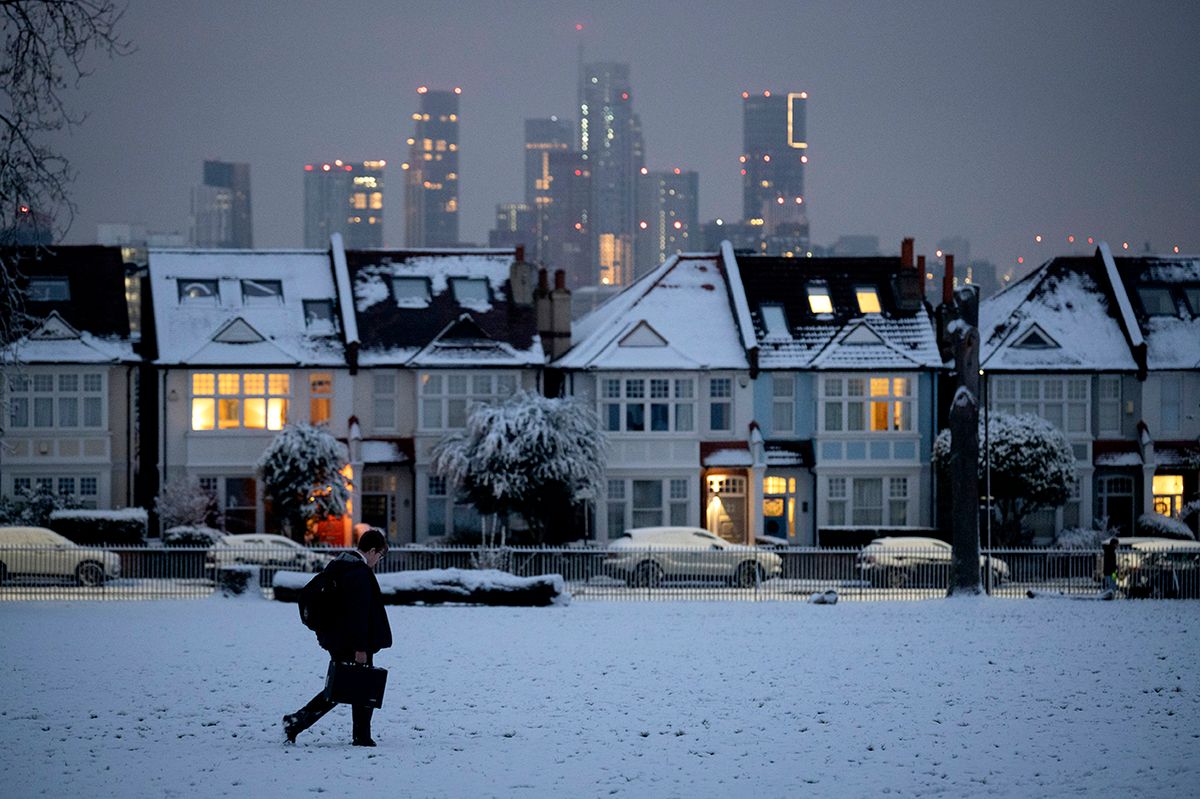 South London Snow A commuter walks past residential properties after low temperatures and overnight snowfall on south London homes on Ruskin Park in SE24, on 12th December 2022, in London, England. (Photo by Richard Baker / In Pictures via Getty Images)