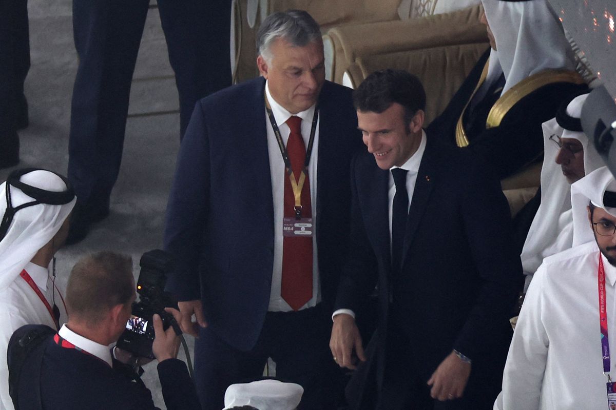 France's President Emmanuel Macron (R) chats with Hungary's Primer Minister Vikor Orban as they wait for the start of the Qatar 2022 World Cup football final match between Argentina and France at Lusail Stadium in Lusail, north of Doha on December 18, 2022.