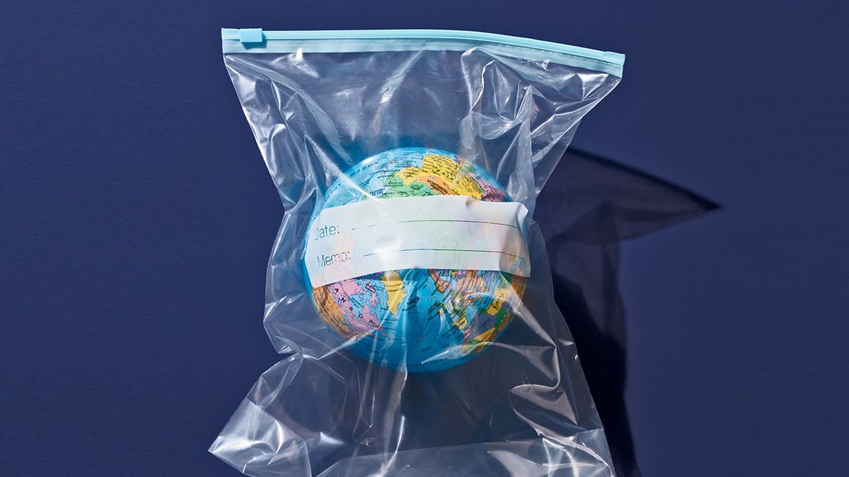 Earth Globe Packed in Plastic Bag Plastic Pollution Concept Image of Earth Globe Packed in Plastic Zipper Bag on Purple Background Directly Above View.