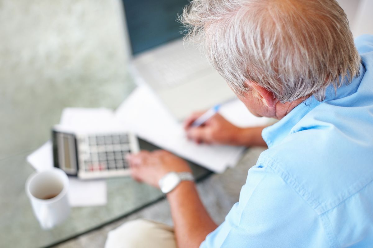 Rear view of a senior man calculating financial budget