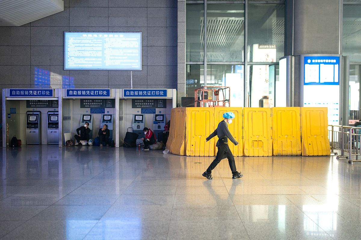 Daily Life In Shanghai NANJING, CHINA - DECEMBER 09: A staff worker walks on the arrival floor at Nanjing South railway station on December 09, 2022 in Nanjing, China. The central government recently eased coronavirus restrictions. PCR tests on arrival and health code checking are no longer necessary for intercity travelers. (Photo by Yifan Ding/Getty Images)