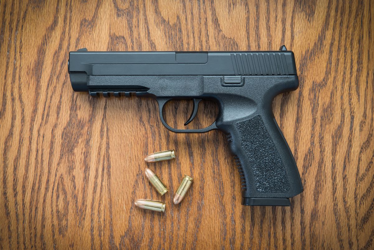 9mm,Handgun,On,Wood,Surface,At,Home