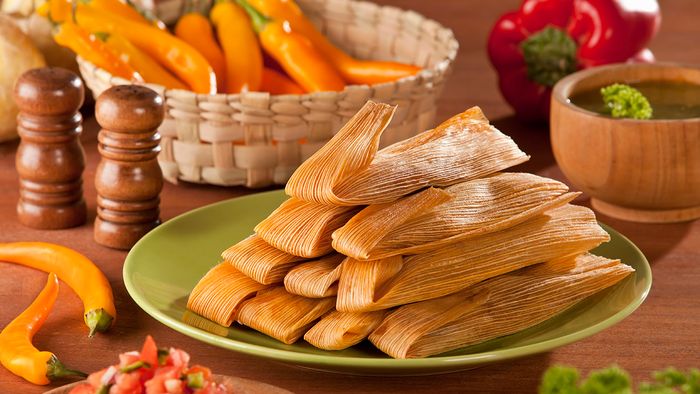 Tamale Traditional Tamales served with avocado and pico de gallo on mexican decoration