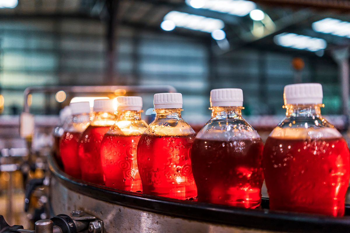 Bottles of red soda in the factory line. italgyártás, üdítő, gyár, termelés, élelmiszeripar