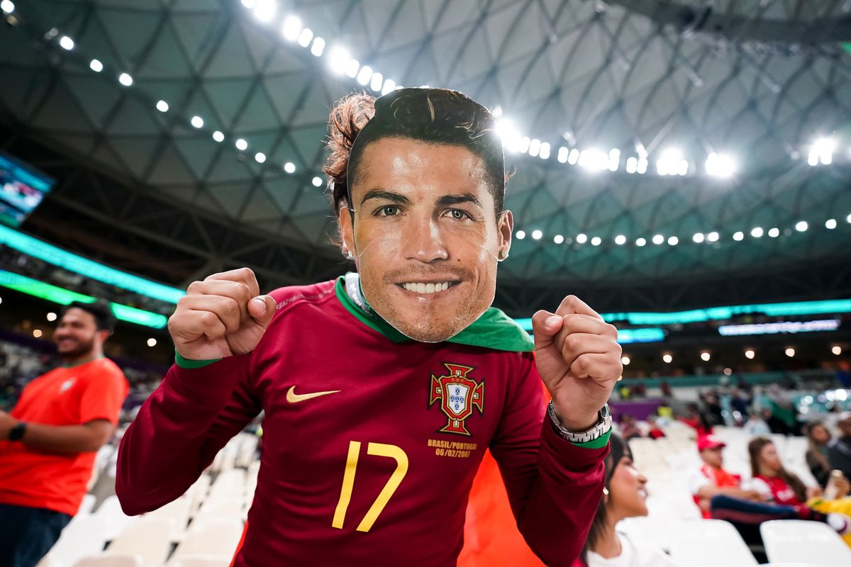 DOHA, QATAR - DECEMBER 6: Supporter of Portugal with a Cristiano Ronaldo mask poses for a photo before the FIFA World Cup Qatar 2022 Round of 16 match between Portugal and Switzerland at Lusail Stadium on December 6, 2022 in Lusail, Qatar. 