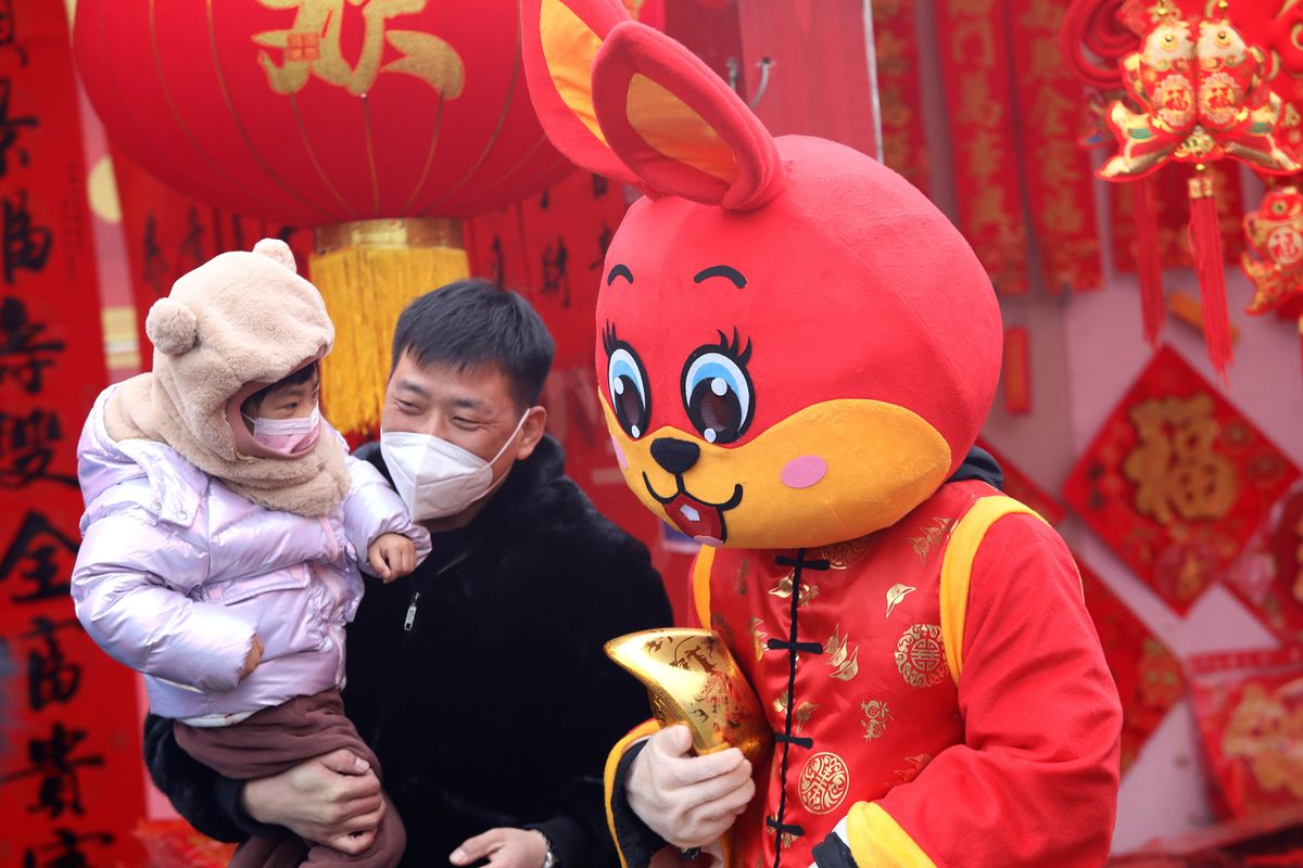 SHIJIAZHUANG, CHINA - JANUARY 13: People pose for photos with a staff member in rabbit costume at a market ahead of the Chinese New Year, the Year of the Rabbit, on January 13, 2023 in Shijiazhuang, Hebei Province of China. 