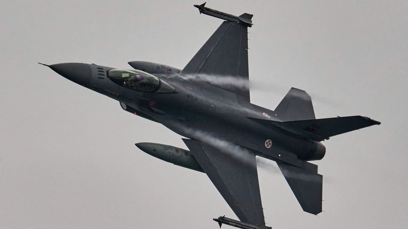 OEIRAS, PORTUGAL - OCTOBER 16: A Portuguese Air Force F16 flies over Santo Amaro Beach during Oeiras Valley Air Show, an aerobatics festival integrated in the Portugal Air Summit'22, on October 16, 2022 in Oeiras, Portugal. The festival included various aerobatics performances with airplanes from the Air Race Championship, a Supermarine Spitfire, and air shows by former world champions Ramón Alonso, Castor Fantoba, Jorge Macias, Luís Garção, Quijote, Jacobstars and The Raven Team. It also had an overflight of the Portuguese Air Force F16s and, at the end of the afternoon, Aerosparx team illuminating Santo Amaro water mirror with fireworks launched from the airplanes' wings.