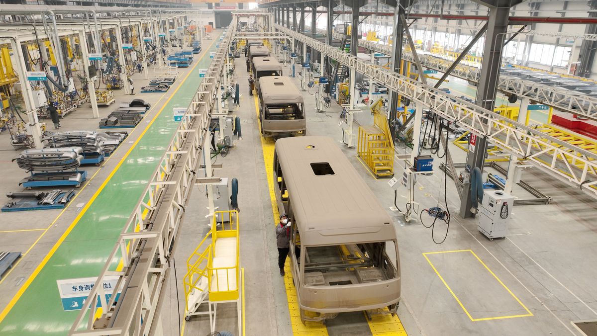 HUZHOU, CHINA - JANUARY 05: Employees work on the assembly line of electric coach at a plant of Qihang Automobile Co., Ltd on January 5, 2023 in Huzhou, Zhejiang Province of China. 