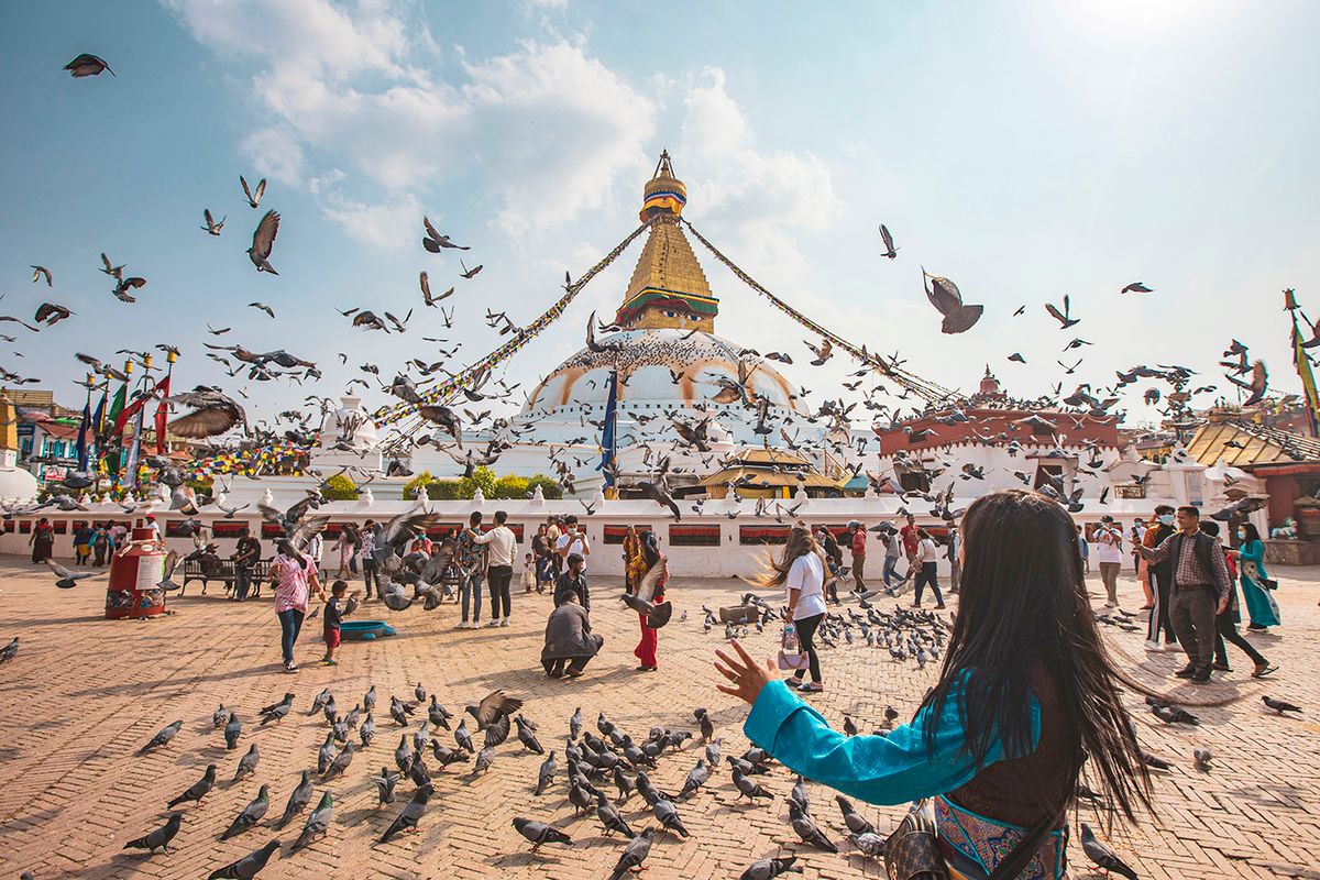 Bouddha Stupa In Kathmandu A UNESCO World Heritage Site Tourist and locals feed and take pictures with the pigeons in the premises of the Stupa. Boudhanath or Bouddha Stupa in Kathmandu a UNESCO World Heritage Site and a legendary place for the Newar and Tibetan Buddhist mythology with the golden part having the Eyes of Boudhanath and the praying flags. One of the most popular tourist attraction in Kathmandu, the mandala makes it one of the largest spherical stupas in Nepal and the world. The Stupa was damaged in the 2015 April earthquake. The Stupa is located on the ancient trade route from Tibet, and the Tibetan Refugees after the 1950s decided to live around Boudhanath. Nepalese people or Buddhist and Hindu pilgrims from abroad offer Kora with a face mask due to the Covid-19 Coronavirus pandemic while other devotees offer prayers next to the burning flames and incense around the Stupa and tourists the pigeons. Kathmandu, Nepal on April 14, 2022  (Photo by Nicolas Economou/NurPhoto via Getty Images)