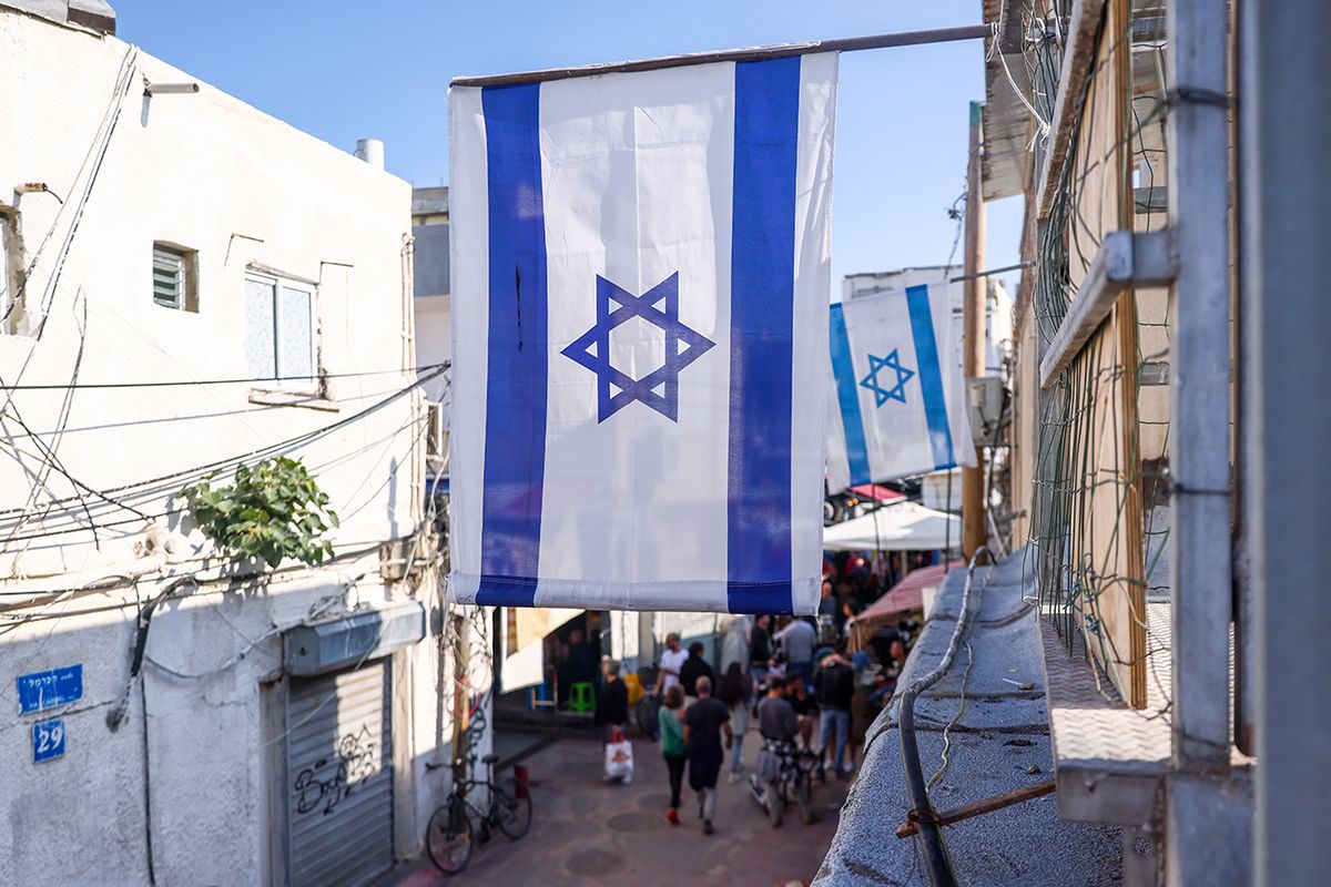 Business And Economy In Tel Aviv Israeli flags are seen near Carmel Market (Shuk Ha'Carmel) in Tel Aviv, Israel on December 30, 2022. (Photo by Beata Zawrzel/NurPhoto via Getty Images)