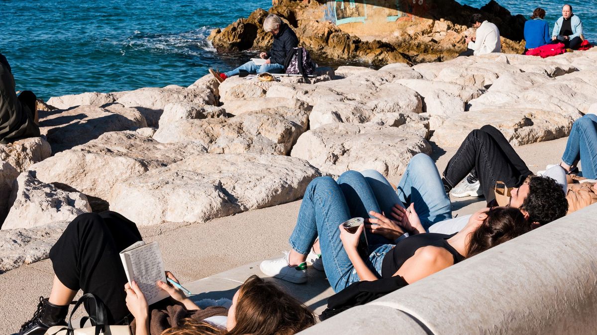 Visitors sit in the sun at Corniche Kennedy in Marseille, France, on Thursday, Jan. 5, 2023. Europe is set for the warmest January in years, easing an energy crunch that has hammered the region for months. 