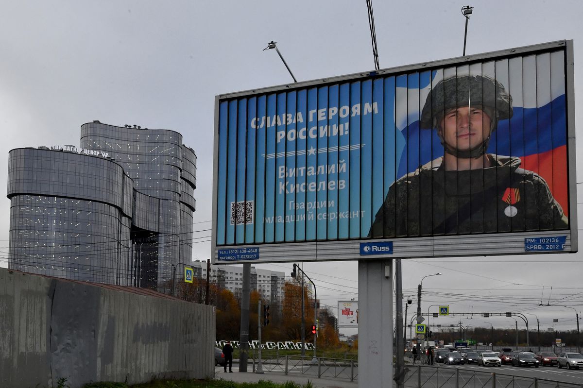 This general view taken on November 4, 2022, shows a poster displaying a Russian soldier with a slogan reading 'Glory to the Heroes of Russia' decorating a street near the 'PMC Wagner Centre', associated with the founder of the Wagner private military group (PMC) Yevgeny Prigozhin, during the official opening of the office block on the National Unity Day, in Saint Petersburg.