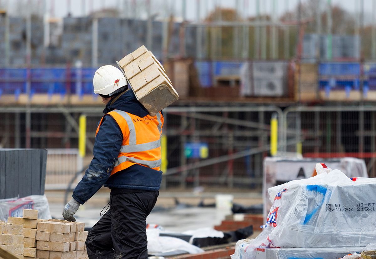 Inside A Bellway Plc Home Construction Site An employee carries a hod of bricks on a new build house under construction on a Bellway Plc residential construction site in Bacton, UK, on Friday, Dec. 2, 2022. More than half of Britons planning to buy a home in the next two years said their home-buying plans had either been brought forward or remained unchanged, according to a Bloomberg Intelligence survey. Photographer: Chris Ratcliffe/Bloomberg via Getty Images