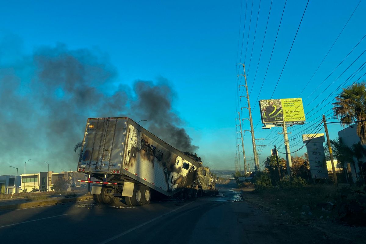 A burning truck is seen across a street during an operation to arrest the son of Joaquin "El Chapo" Guzman, Ovidio Guzman, in Culiacan, Sinaloa state, Mexico, on January 5, 2023. - Intense gunfire rocked a cartel heartland in northwestern Mexico on Thursday after security forces launched an operation in which a son of jailed drug kingpin Joaquin "El Chapo" Guzman was reportedly arrested. 