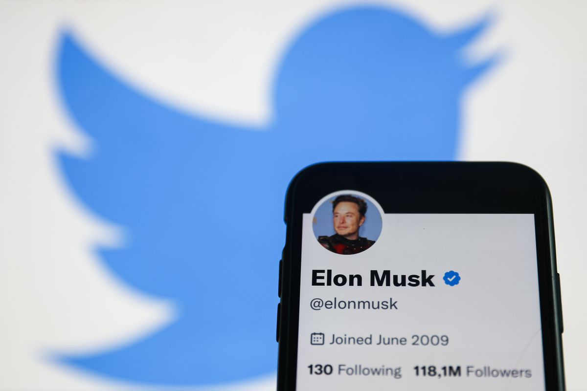 Elon Musk Twitter account displayed on a phone screen and Twitter logo displayed on a screen in the background are seen in this illustration photo taken in Krakow, Poland on November 22, 2022. 
