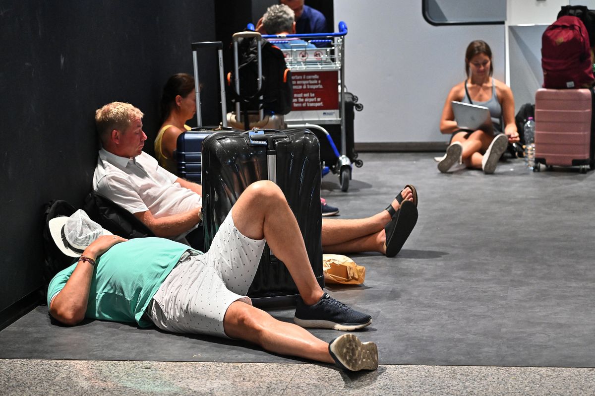 Passengers wait at Rome's Fiumicino airport during a strike by workers of some airline companies which forcibly cancelled hundreds of flights, in Rome, on July 17, 2022. 