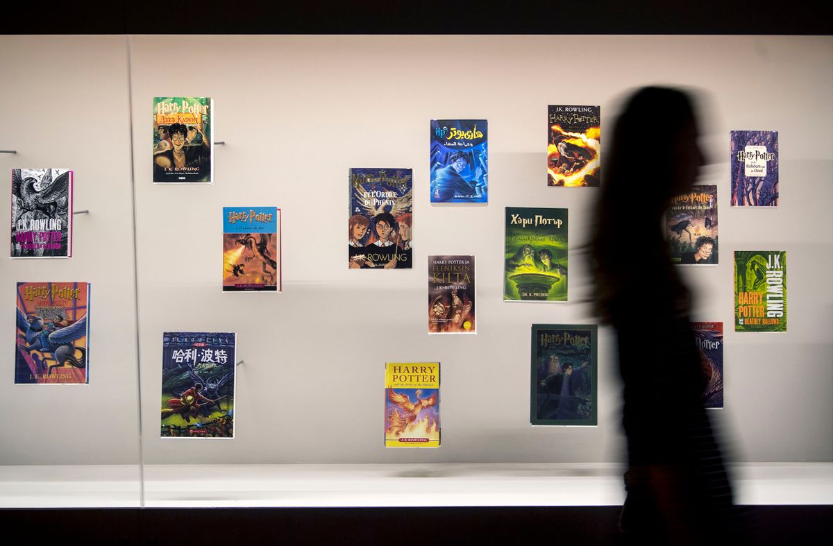 A visitor walks past a display of foreign language editions of the Harry Potter books during a press preview for the Harry Potter: A History of Magic exhibition at the British Library in London. 
