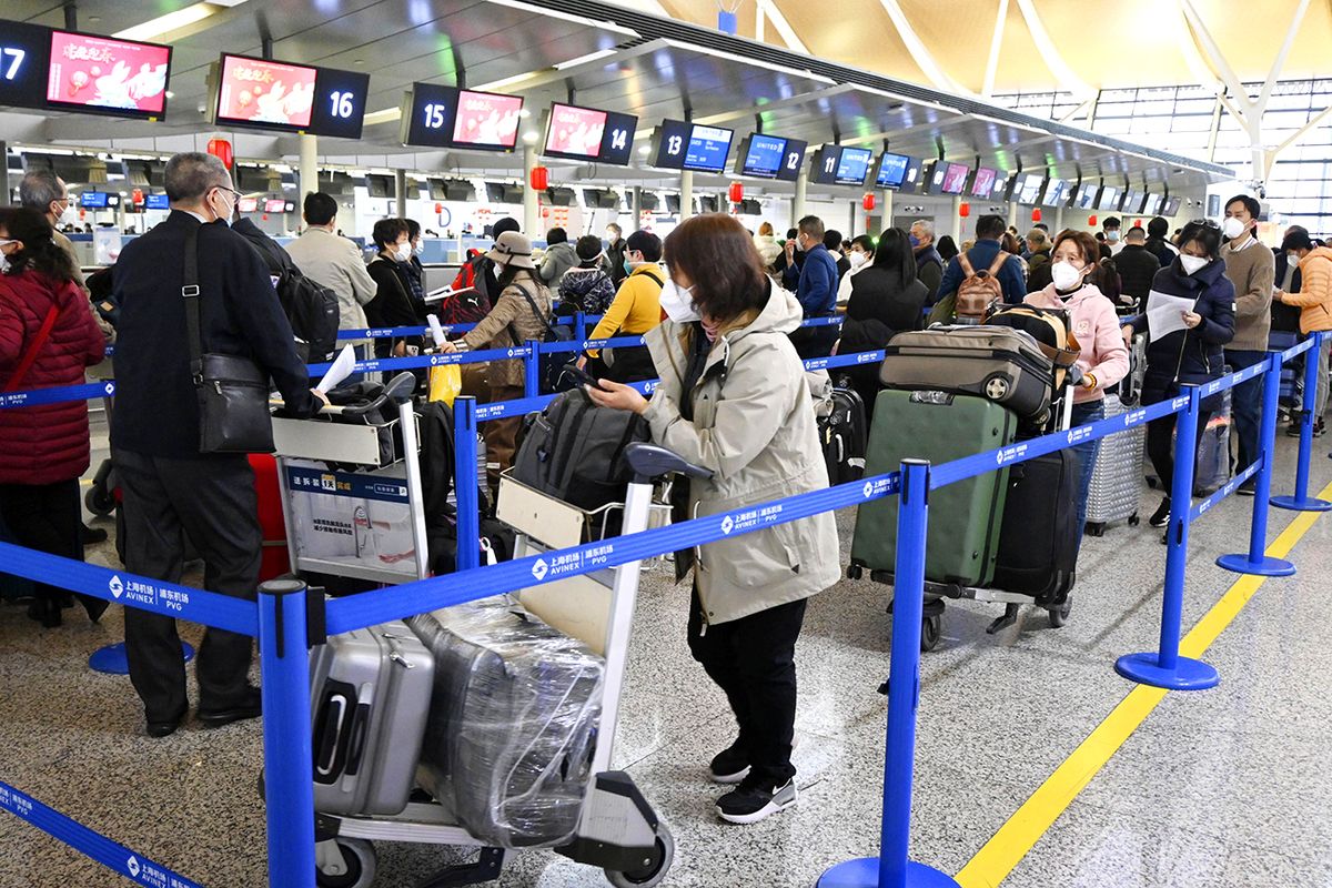 New Year holidays in ChinaTravelers form a line at a Shanghai Pudong International Airport counter on Jan. 21, 2023, as the Lunar New Year holidays start in China. (Photo by Kyodo News via Getty Images)