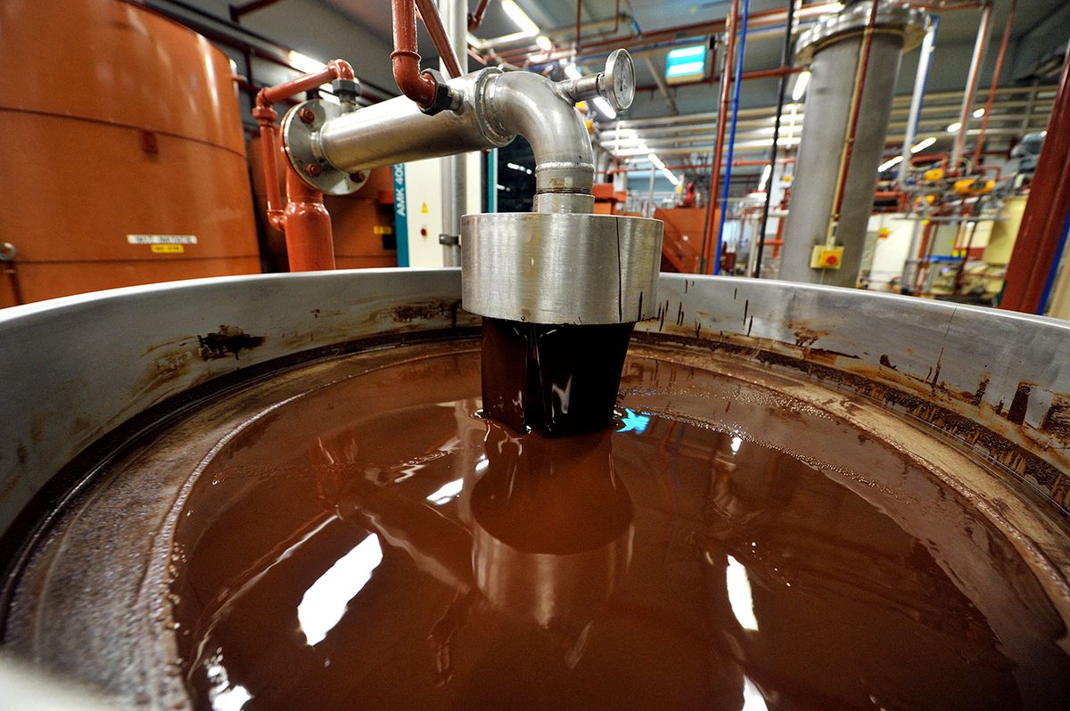 A picture shows hot chocolate before being moulded at the Barry Callebaut chocolate factory in Wieze, Belgium, on July 8, 2013. The industrial group Barry Callebaut buys around a quarter of the world's cocoa bean production and produces 900 tons a day of chocolate. AFP PHOTO / GEORGES GOBET (Photo by GEORGES GOBET / AFP)