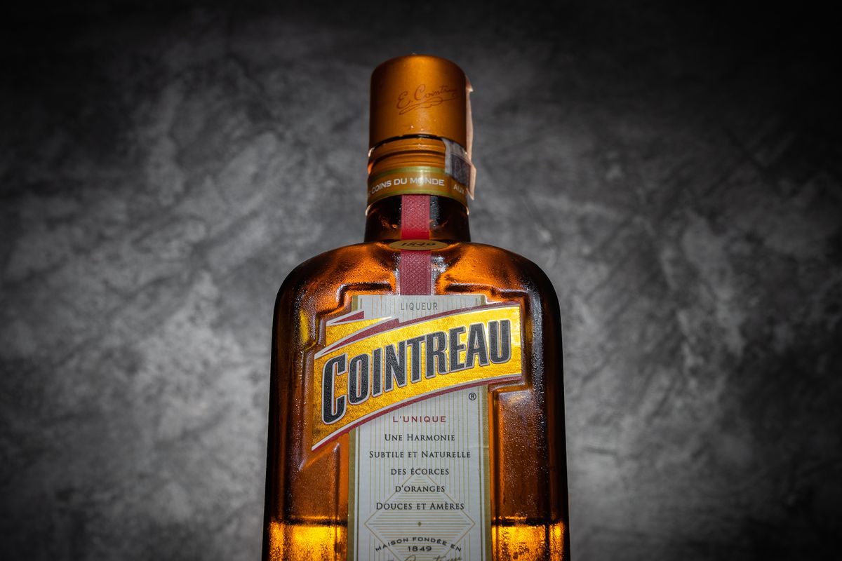 MIEKINIA, POLAND - AUGUST 9, 2022: Cointreau liqueur bottle. Orange-flavoured alcohol drink used in margarita cocktails. Triple sec liqueur by French company Rémy Cointreau in France.