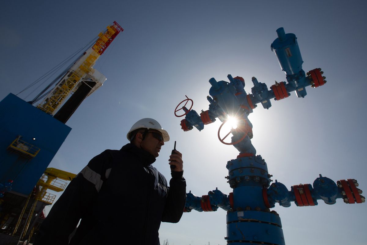 A worker speaks on a handheld transceiver at a gas well near to the Gazprom PJSC gas drilling rig in the Kovyktinskoye gas field, part of the Power of Siberia gas pipeline project, near Irkutsk, Russia, on Wednesday, April 7, 2021. Built by Russian energy giant Gazprom PJSC, the pipeline runs about 3,000 kilometers (1,864 miles) from the Chayandinskoye and Kovyktinskoye gas fields in the coldest part of Siberia to Blagoveshchensk, near the Chinese border.