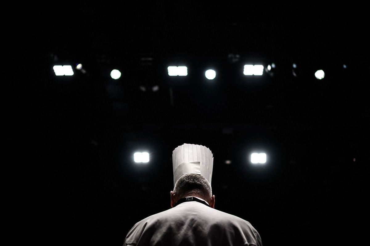 A chef watches chefs competing in the 2023 Bocuse d’Or competition at the SIRHA (Salon International de la Restauration, de l’Hotellerie et de l’Alimentation) in the Chassieu Eurexpo hall near Lyon on January 22, 2023