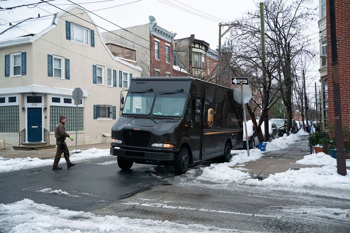 Winter Storm Bears Down On Northeast A United Parcel Service Inc. (UPS) driver driver returns after delivering a package following a winter storm in Philadelphia, Pennsylvania, U.S., on Thursday, Dec. 17, 2020. A nor'easter is causing the first major snowstorm of the season to bear down on the tri-state area, potentially dumping up to a foot of snow in some parts, with frigid temperatures, gusty winds and sleet making conditions even worse. Photographer: Caroline Gutman/Bloomberg via Getty Images